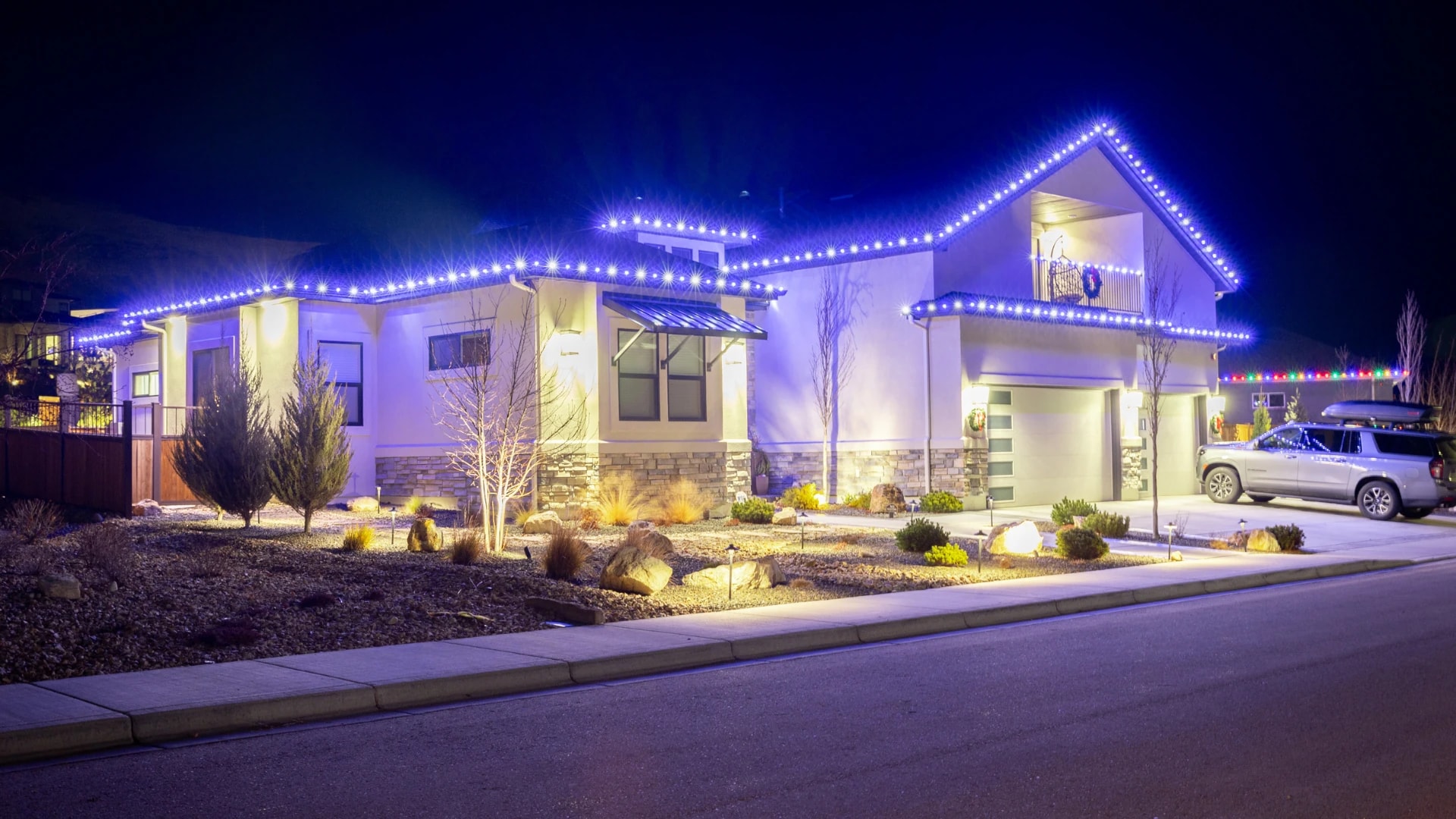 After blue roofline Christmas light installation on a modern home in Boise, ID by Christmas Light Installation Boise