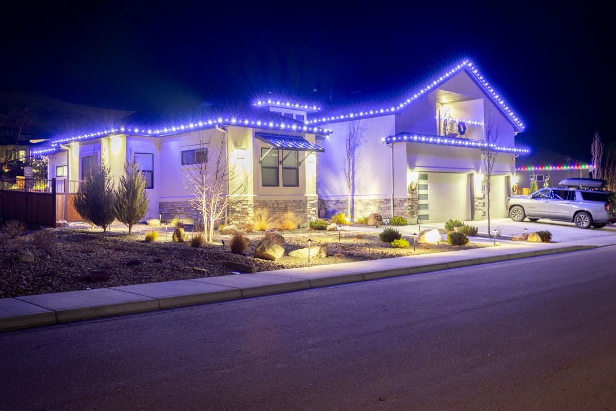 Blue LED roofline Christmas lights on a home at night in Boise, ID by Christmas Light Installation Boise