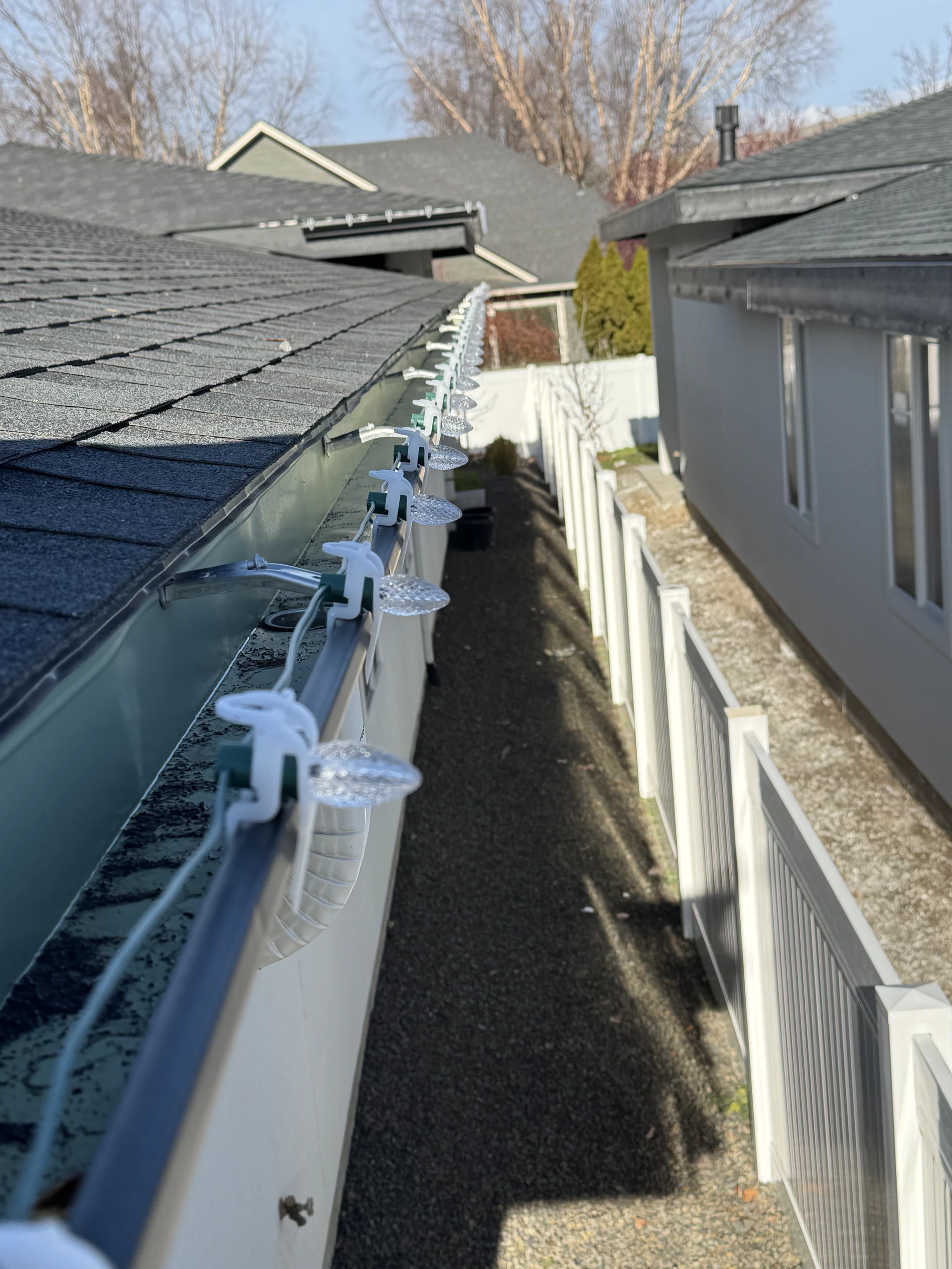 C9 Christmas lights professionally clipped along a side gutter in Boise, ID by Christmas Light Installation Boise