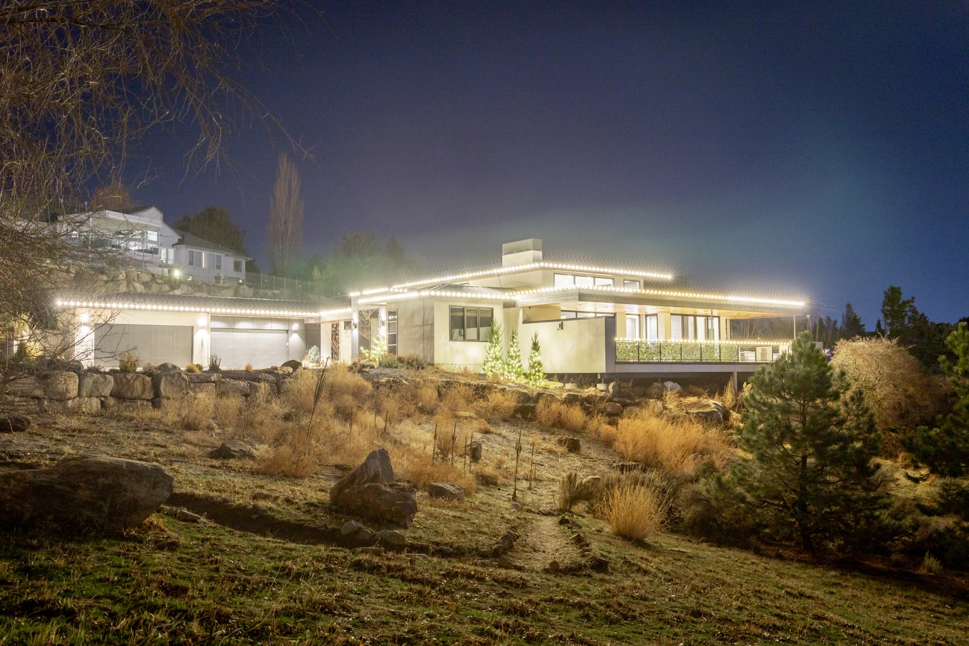 Luxury hillside estate Christmas light installation at night in Boise, ID by Christmas Light Installation Boise