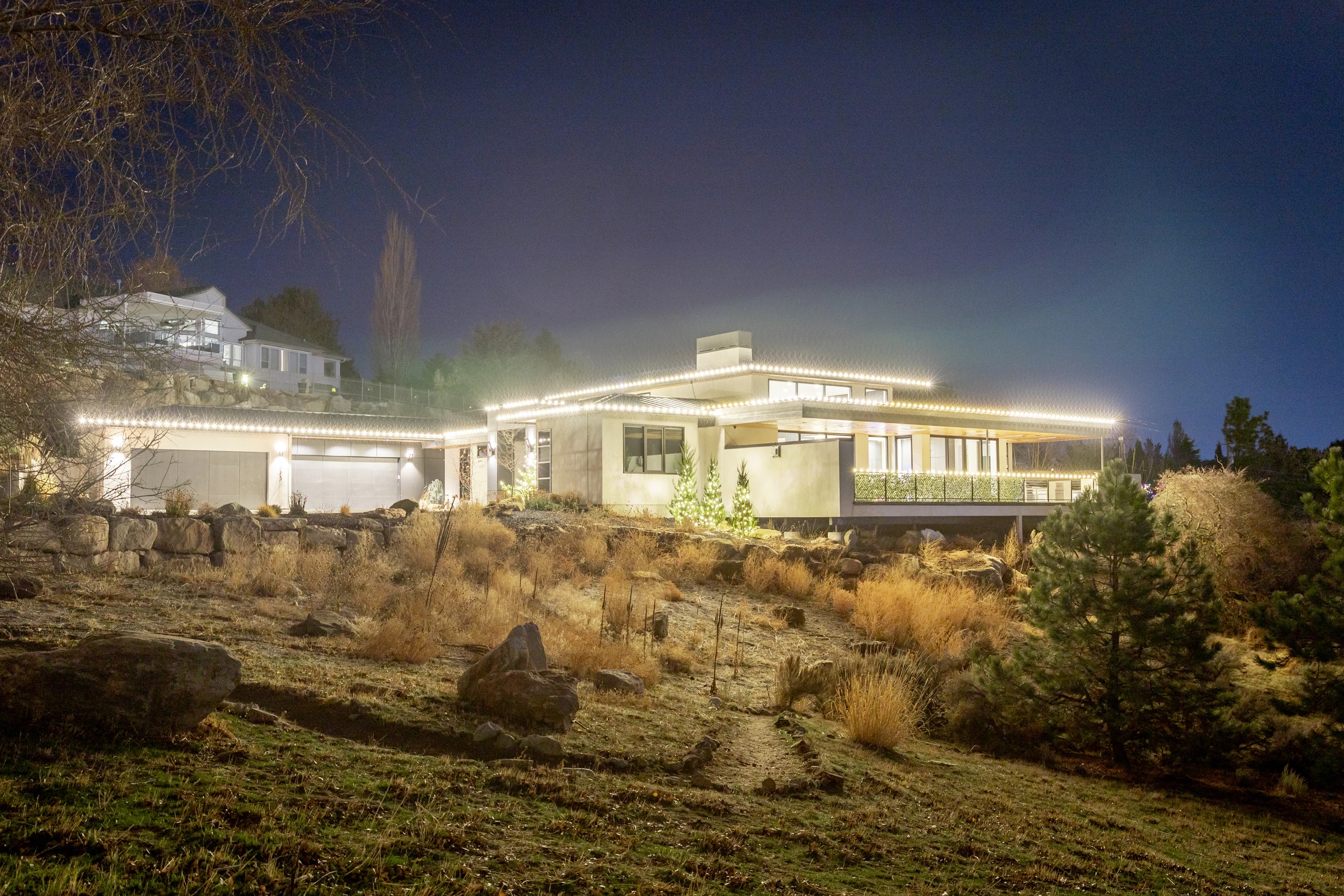 Luxury hillside estate Christmas light installation at night in Boise, ID by Christmas Light Installation Boise