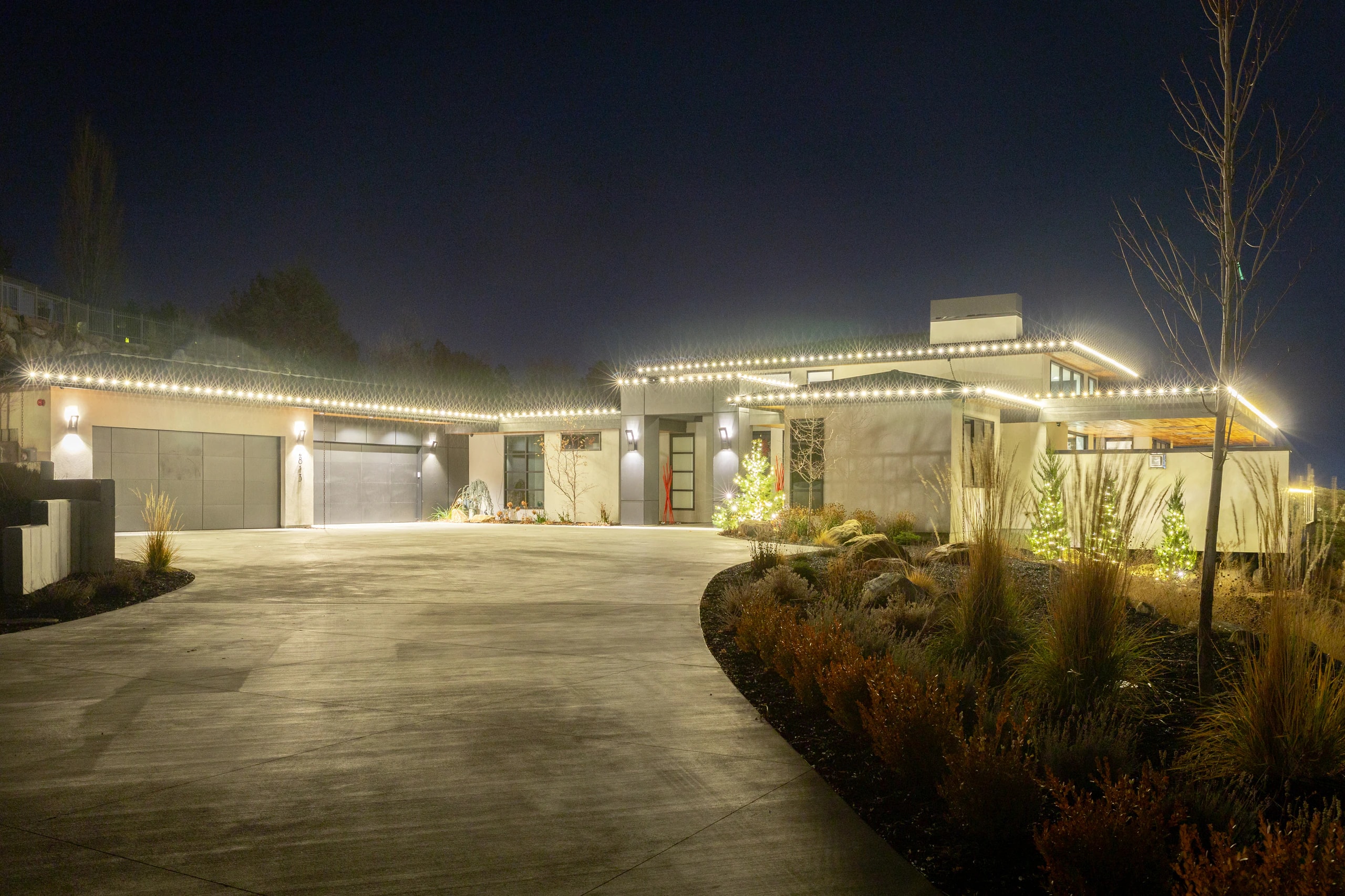 Luxury home driveway Christmas light installation at night in Boise, ID by Christmas Light Installation Boise