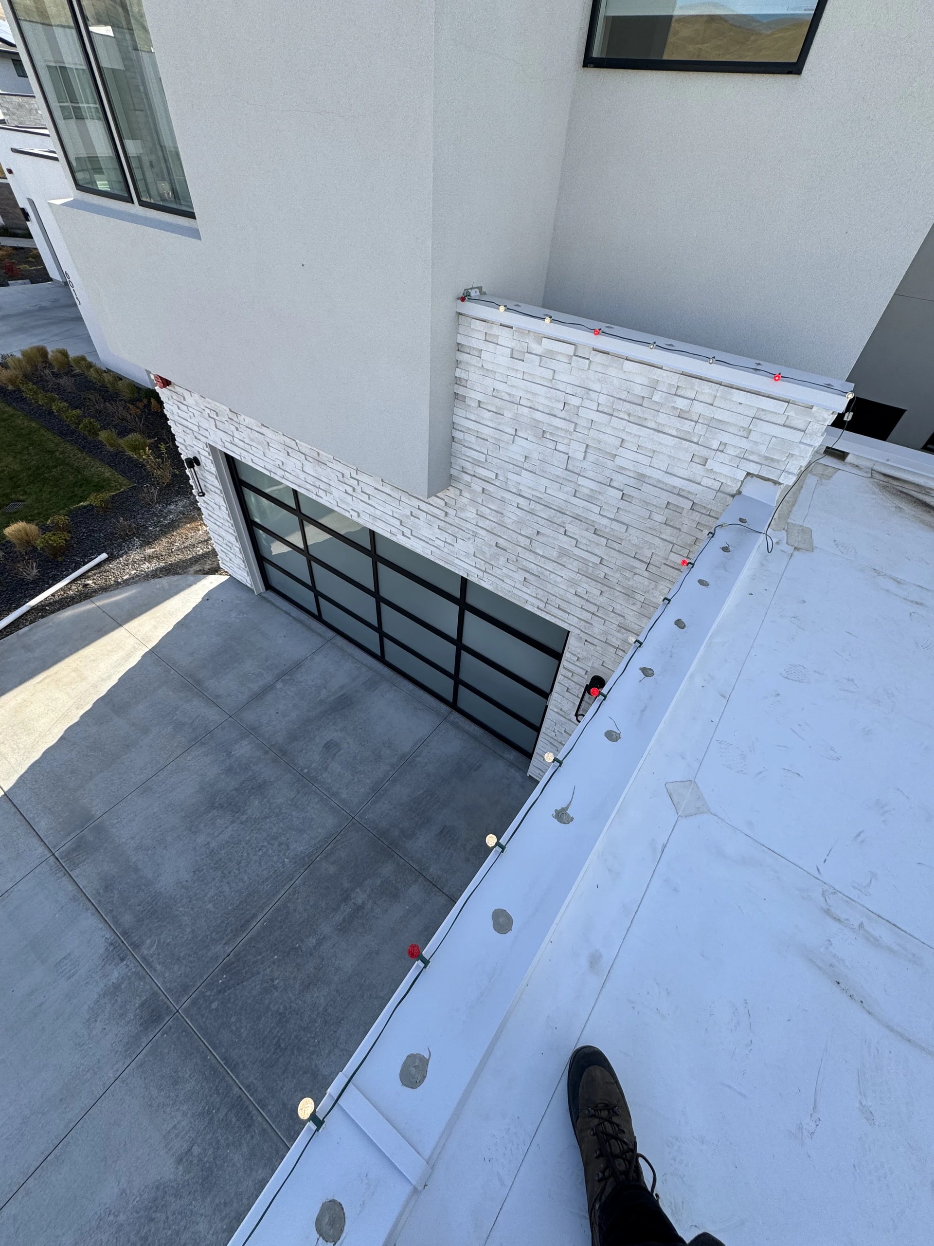 Overhead view of Christmas lights on a modern white home parapet in Boise, ID by Christmas Light Installation Boise