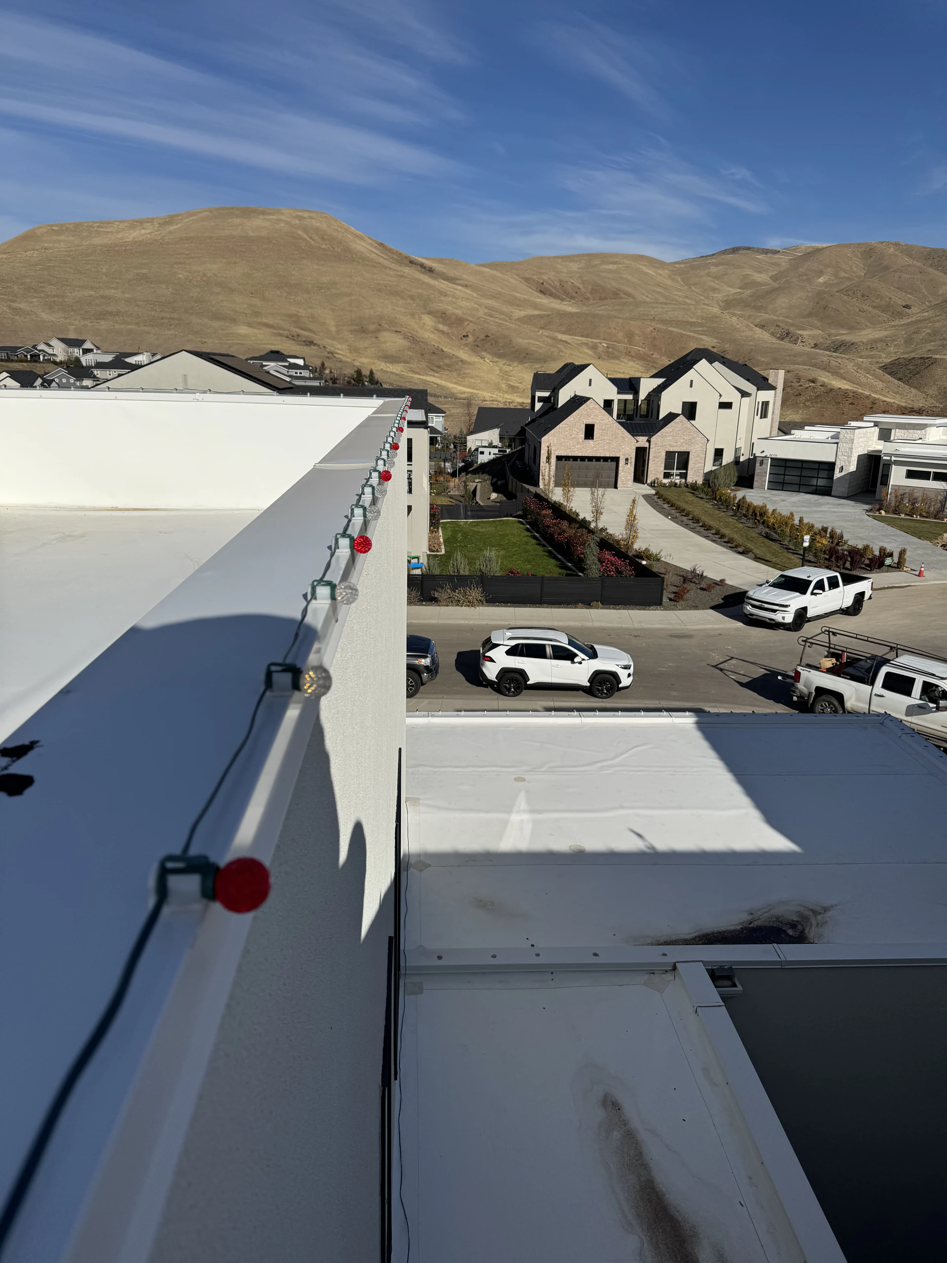 Rooftop holiday light install overlooking the Boise foothills in Boise, ID by Christmas Light Installation Boise