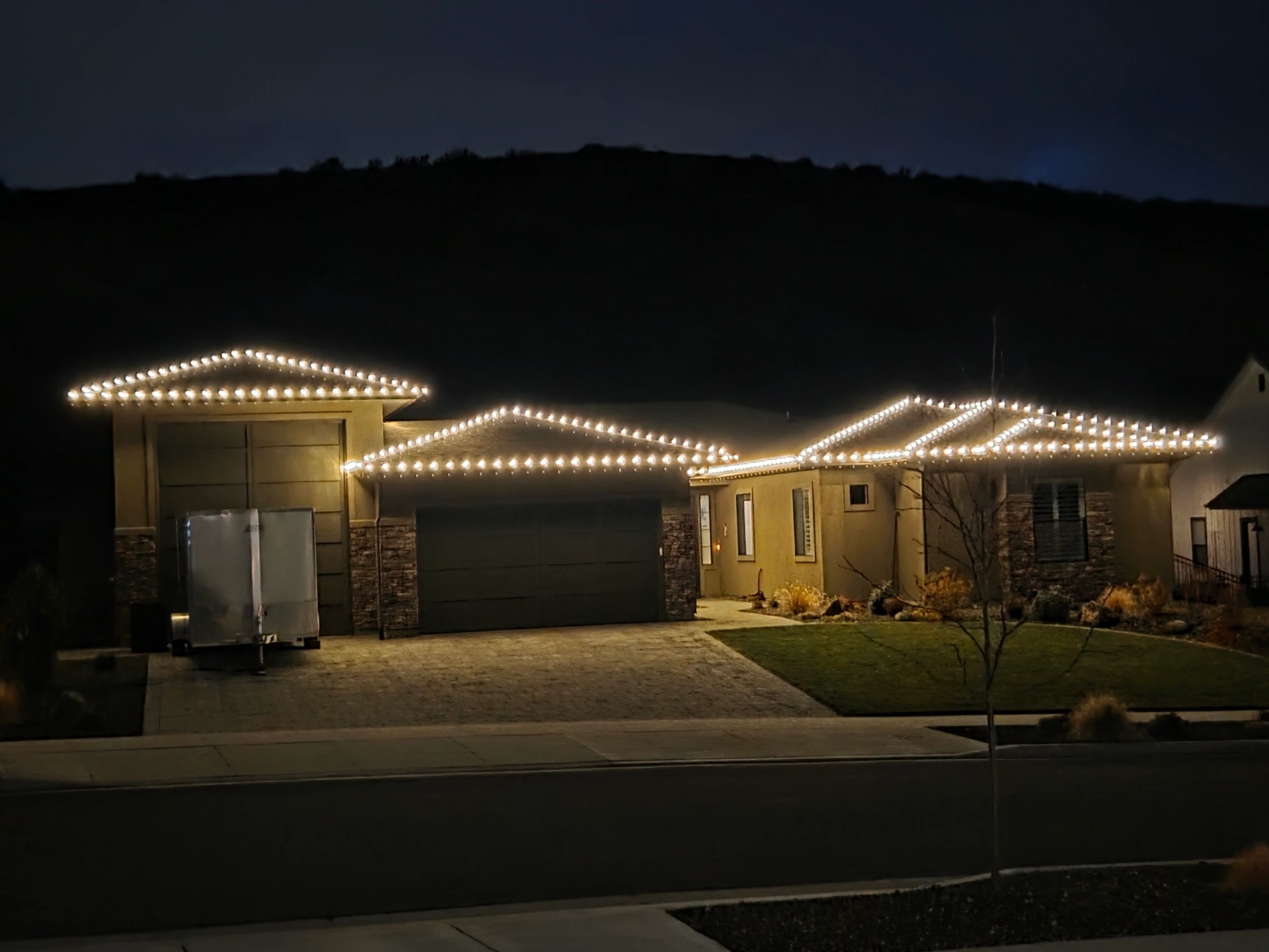 Warm white roofline Christmas lights on a home at night in Boise, ID by Christmas Light Installation Boise